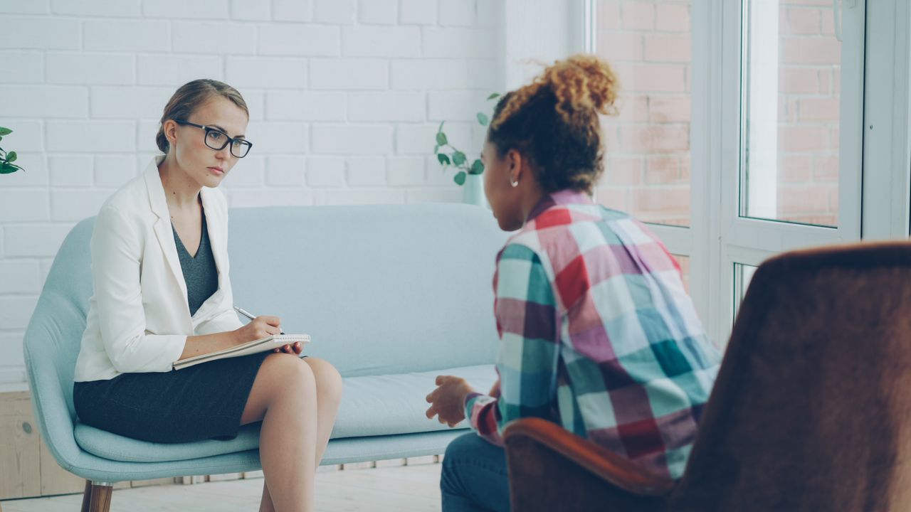 about-me-img A therapist listens attentively during a private counseling session.